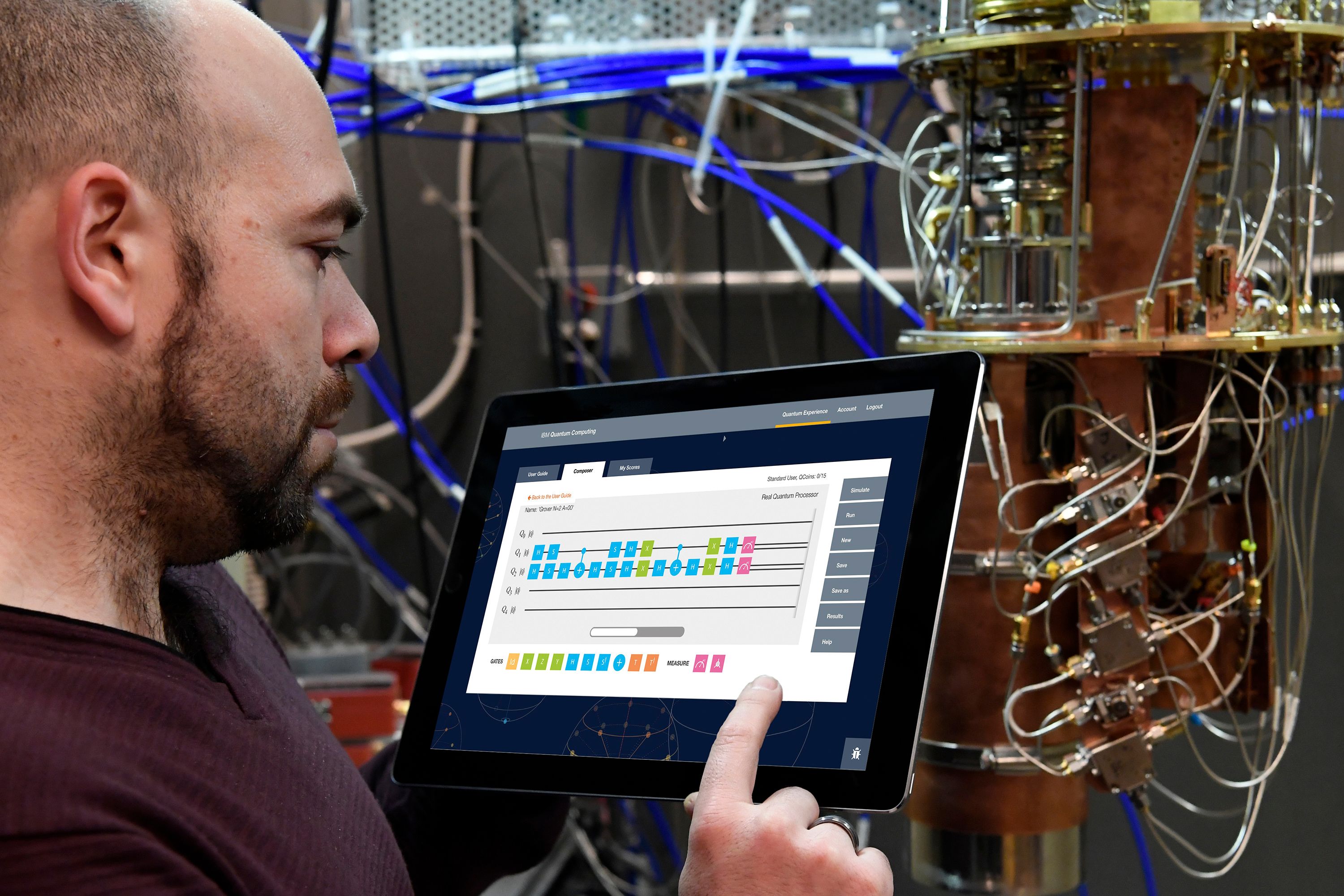 IBM Head of Quantum + HPC and Principal Research Scientist Antonio Corcoles uses the newly debuted IBM Quantum Experience on a tablet in the IBM Quantum Lab while standing next to a dilution refrigerator, 2016. (Jon Simon/Feature Photo Service for IBM) 26709415071_3e0d3a6775_o.jpg