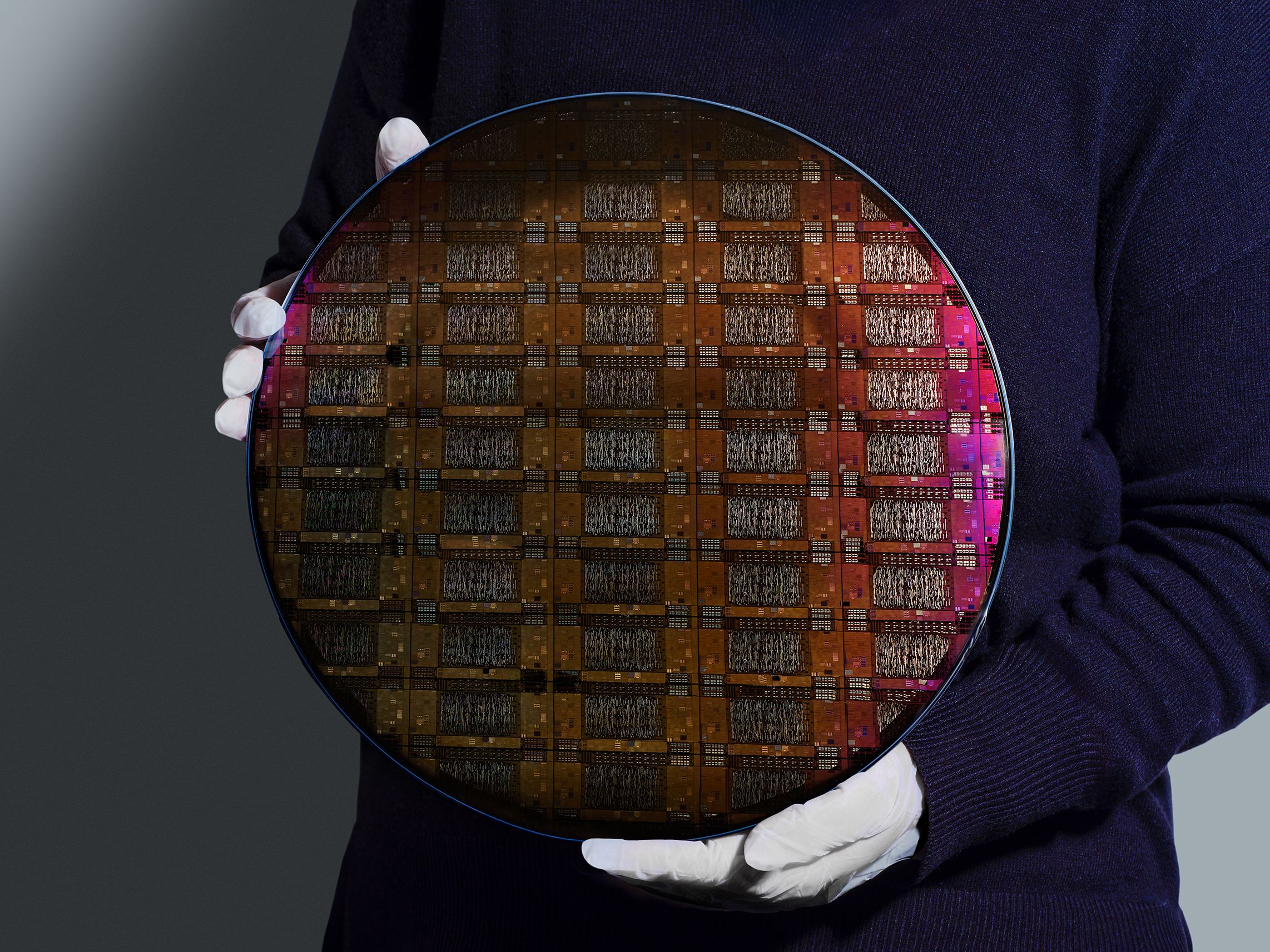IBM researcher holding a 300mm IBM Quantum Loon wafer (Credit: IBM) IBM-Quantum_Loon_300mm_1.jpg